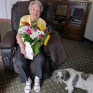 Sylvia Mary Turner aged 95, holding flowers after completing her first AI course certificate